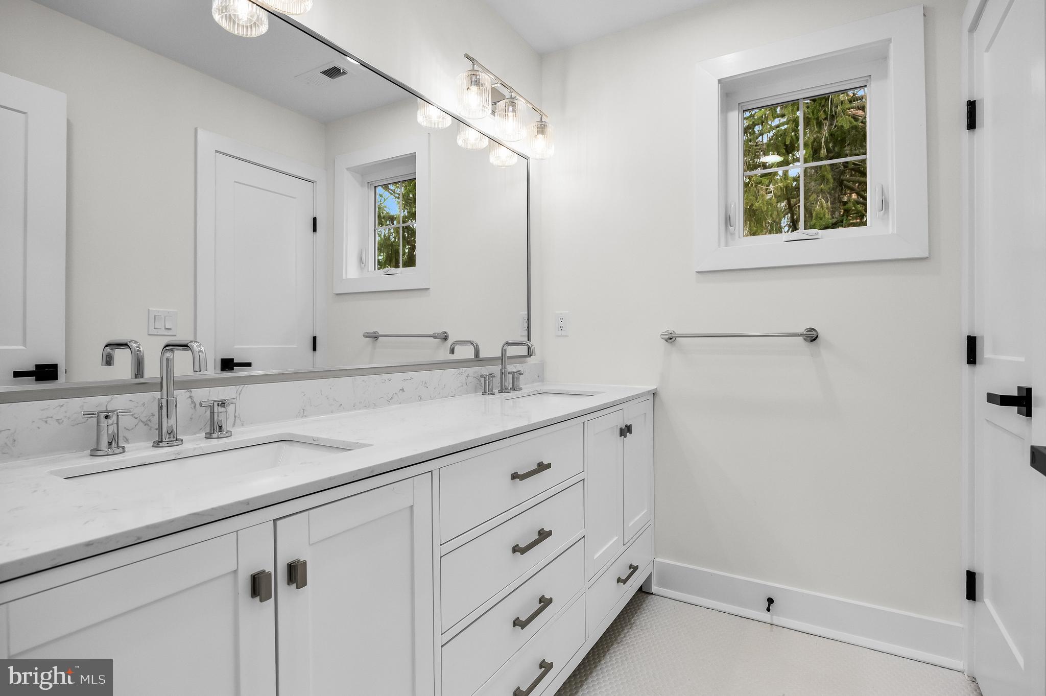 201 Centre Street Haddonfield, NJ 08033 - Photo 30 of 48 a bathroom with double vanity sink a mirror and a shower