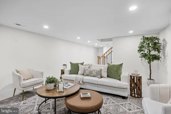 a living room with furniture and a potted plant