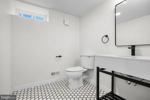 a bathroom with a toilet and a sink