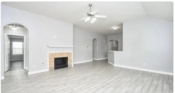 wooden floor in an empty room with a fireplace