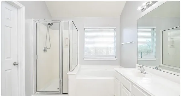 a bathroom with a sink a vanity and a shower