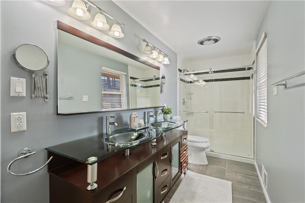 271 Shafer Road Coraopolis, PA 15108 - Photo 23 of 50 The master bath exudes modern elegance with its beautifully updated contemporary vanity, dual sinks and a spaciouss walk-in shower.