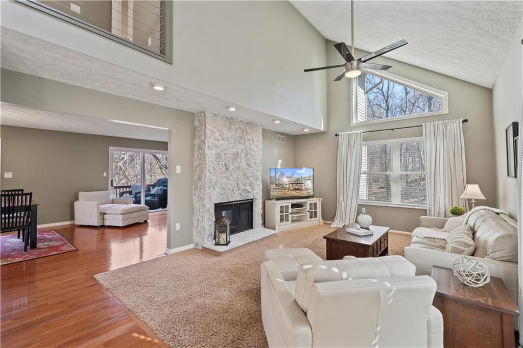 271 Shafer Road Coraopolis, PA 15108 - Photo 4 of 50 The living room and family room are beautifully connected by a striking two-sided stone fireplace, creating warmth and elegance.