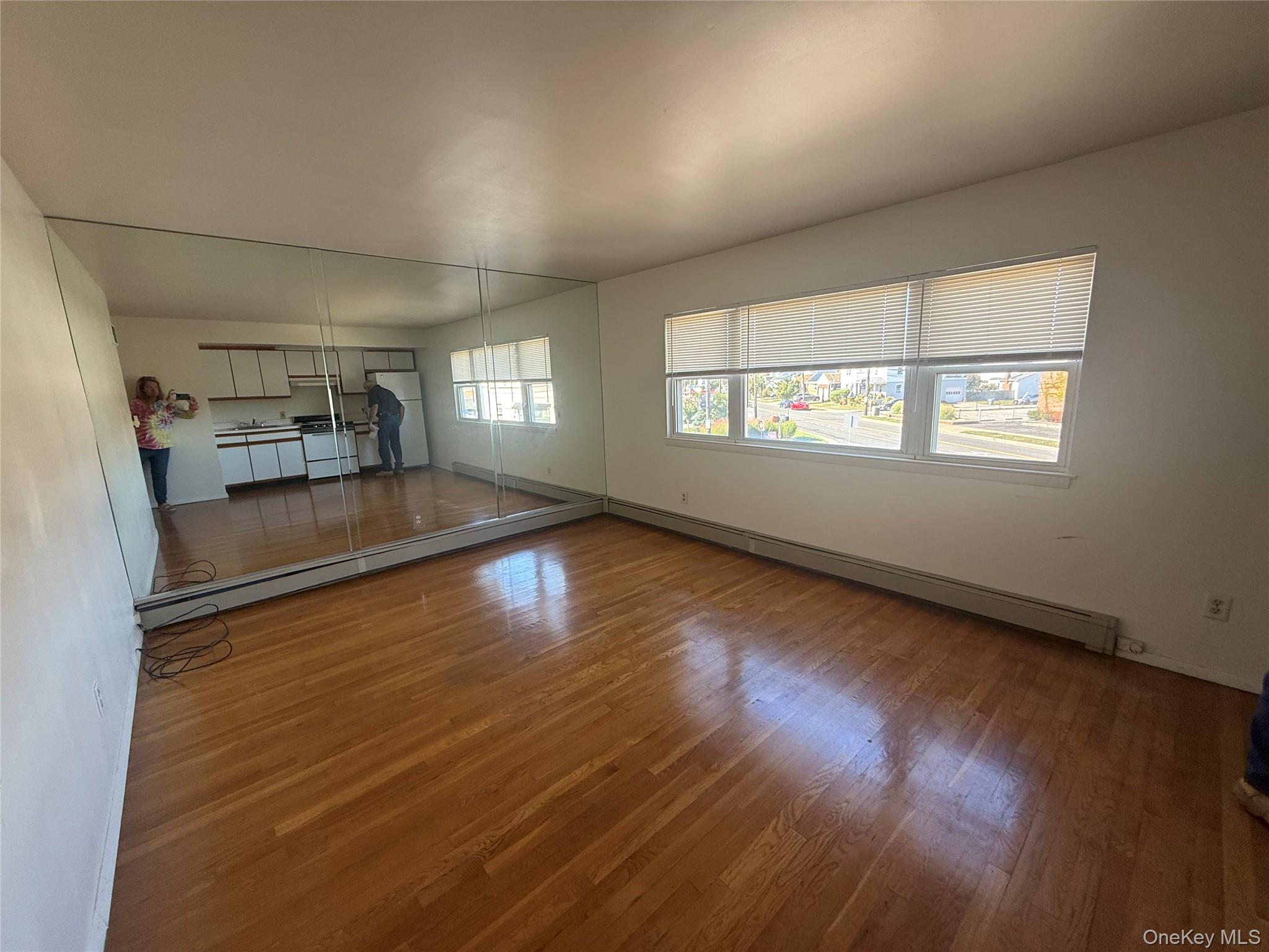 393 Long Beach Road Island Park, NY 11558 - Photo 6 of 6 an empty room with wooden floor and windows