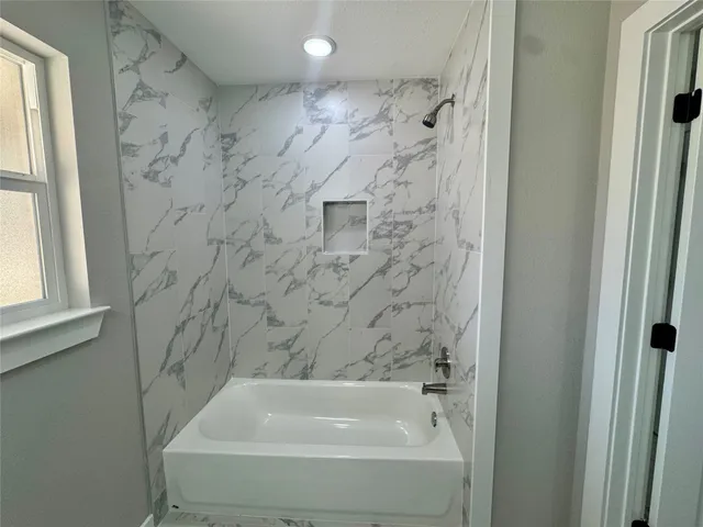 a view of kitchen with refrigerator and cabinets