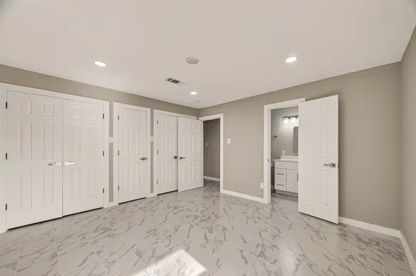 a bathroom with a sink shower and a mirror