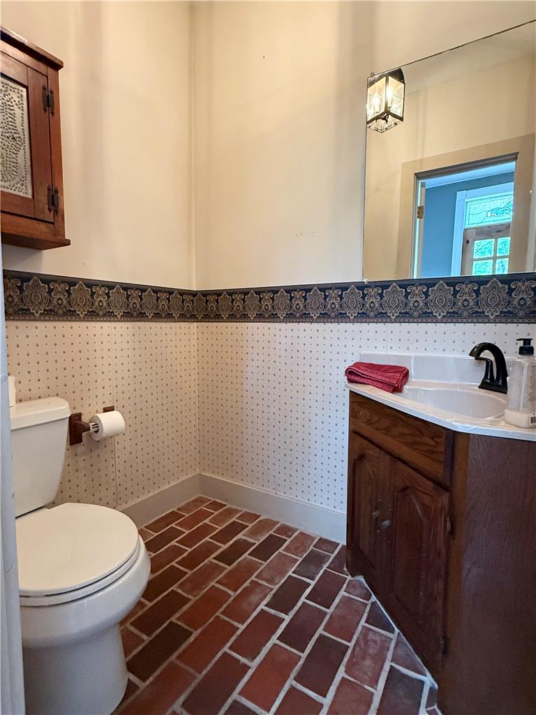 740 Engler Road Nazareth, PA 18064 - Photo 10 of 27 Brick flooring grounds this functional powder room, offering rustic charm.
