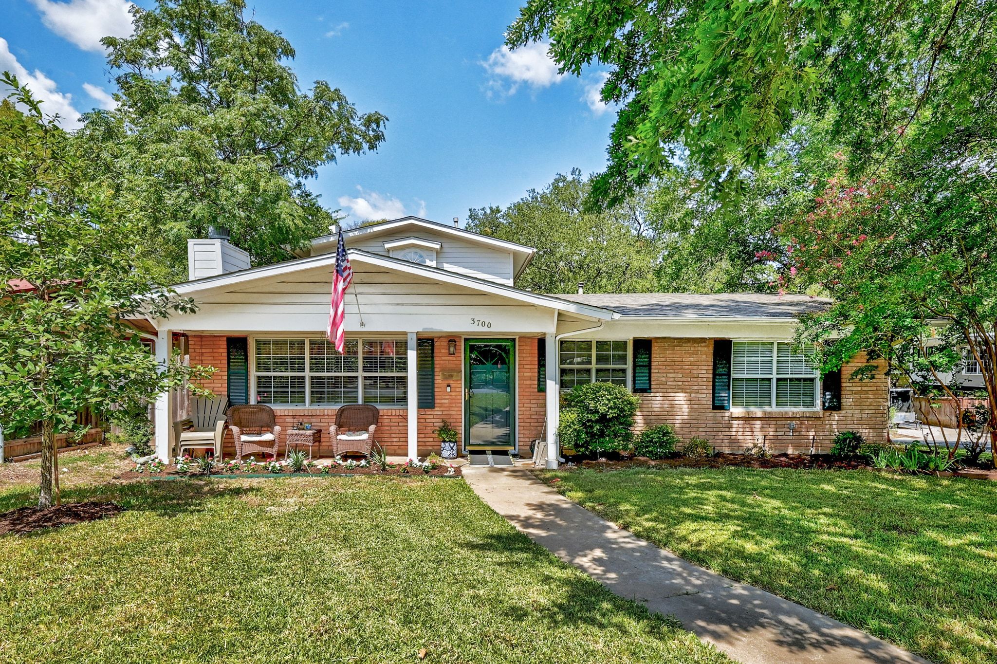 3700 Bonnie Road Austin, TX 78703 - Photo 1 of 1 View of front of home featuring brick siding, a porch, and a front lawn