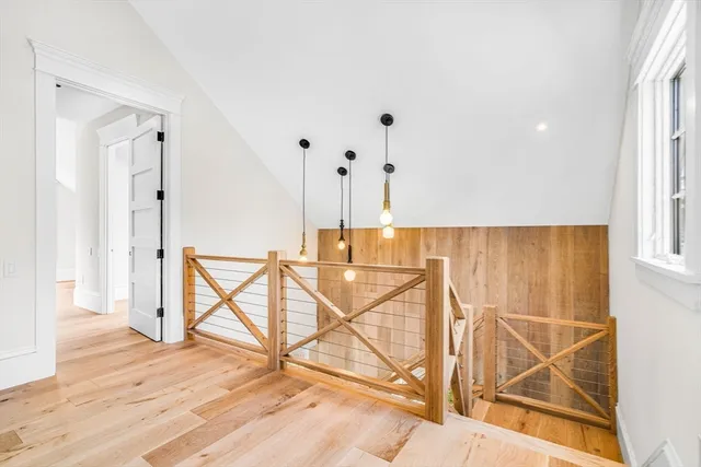 a view of a room with wooden floor and windows