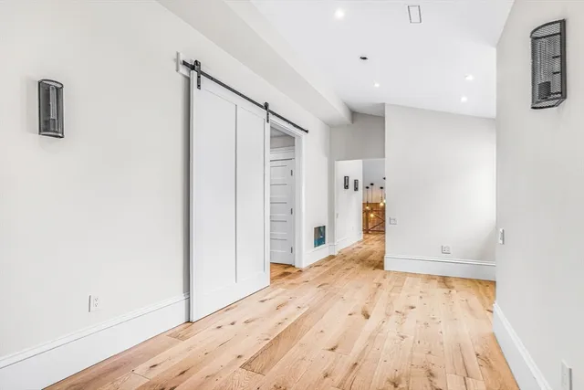 a view of empty room with wooden floor