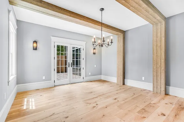 a view of a livingroom with wooden floor and door
