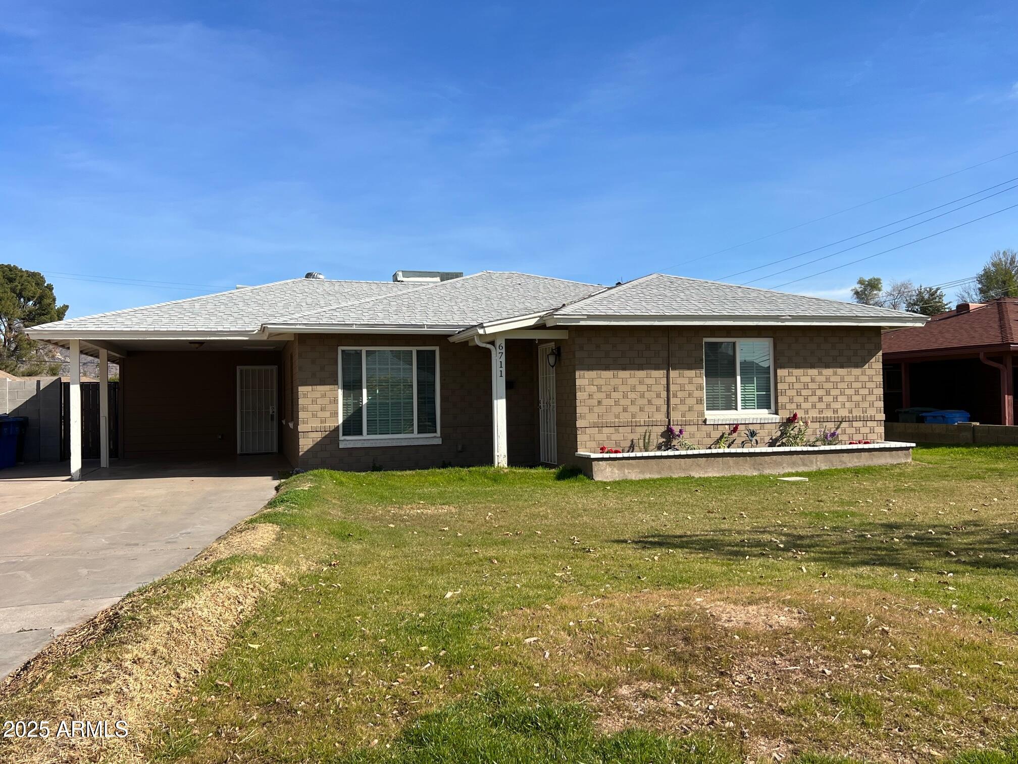 6711 North 14th Place Phoenix, AZ 85014 - Photo 1 of 27 a front view of a house with a garden and porch