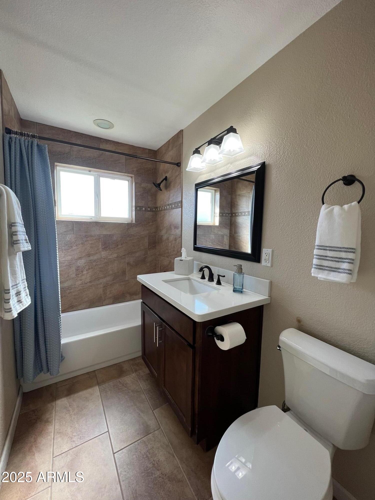 6711 North 14th Place Phoenix, AZ 85014 - Photo 15 of 27 a bathroom with a sink a toilet and mirror