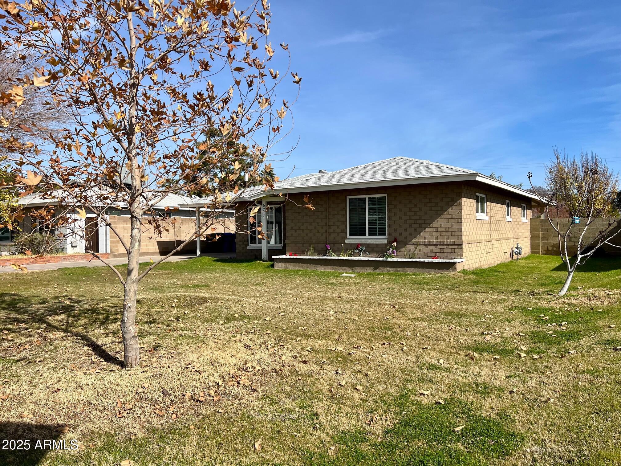 6711 North 14th Place Phoenix, AZ 85014 - Photo 26 of 27 a front view of a house with a yard