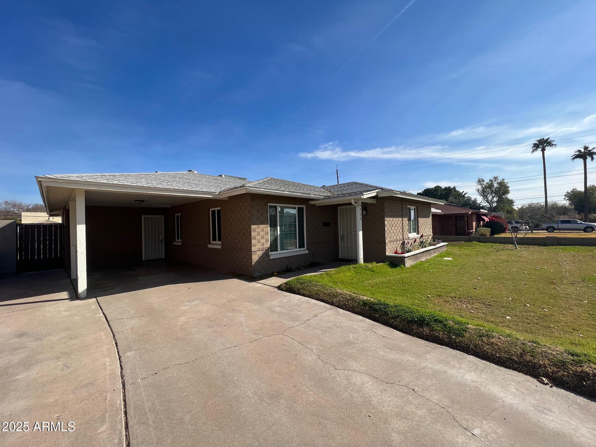 6711 North 14th Place Phoenix, AZ 85014 - Photo 27 of 27 a front view of a house with a yard and garage