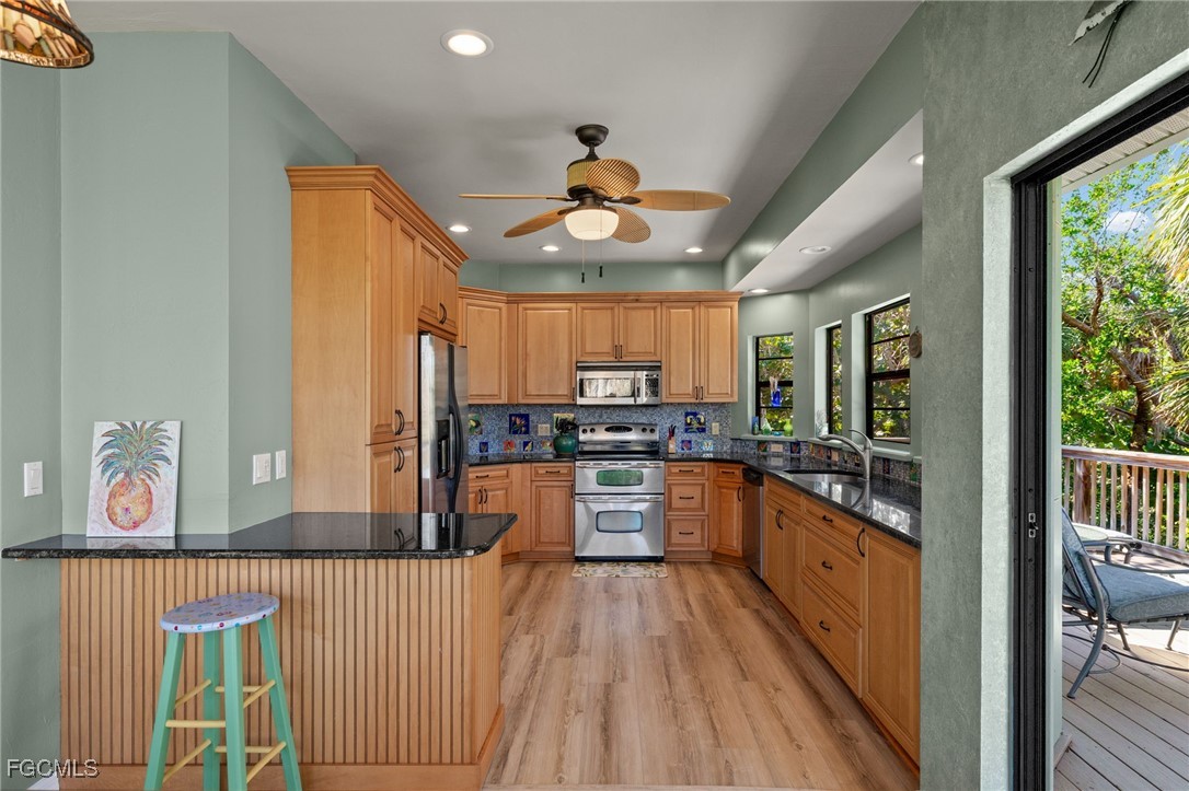 4631 Bowen Bayou Road Sanibel, FL 33957 - Photo 12 of 39 a kitchen with stainless steel appliances granite countertop lots of counter top space