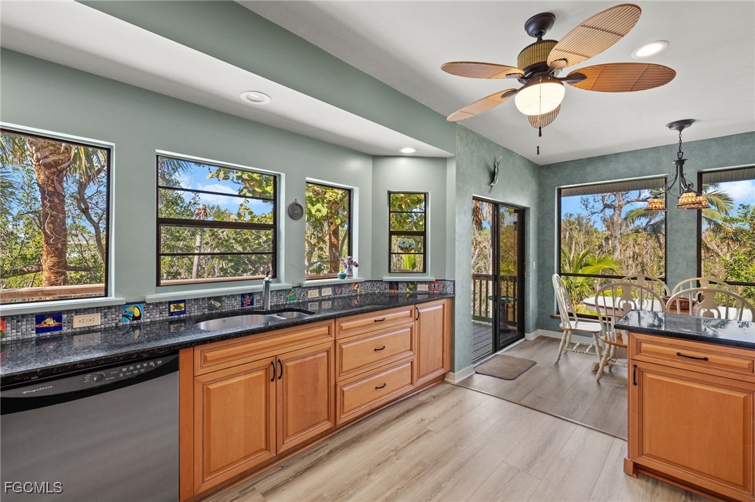 4631 Bowen Bayou Road Sanibel, FL 33957 - Photo 14 of 39 a large kitchen with kitchen island granite countertop a large window cabinets a sink and stainless steel appliances