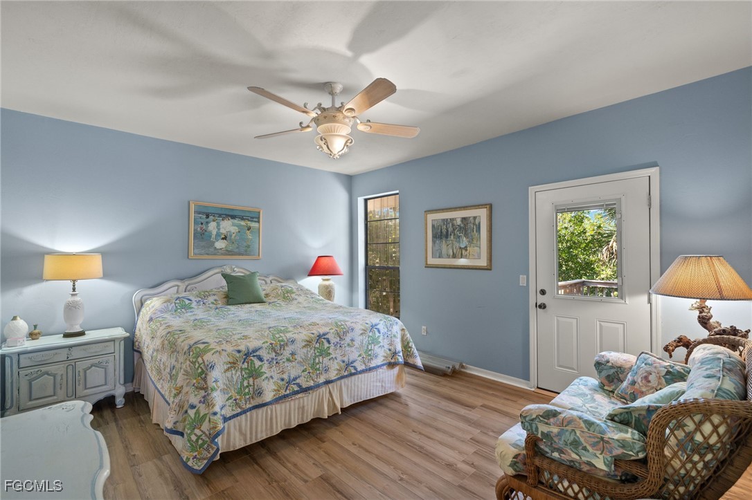 4631 Bowen Bayou Road Sanibel, FL 33957 - Photo 15 of 39 a bedroom with a bed and a chandelier
