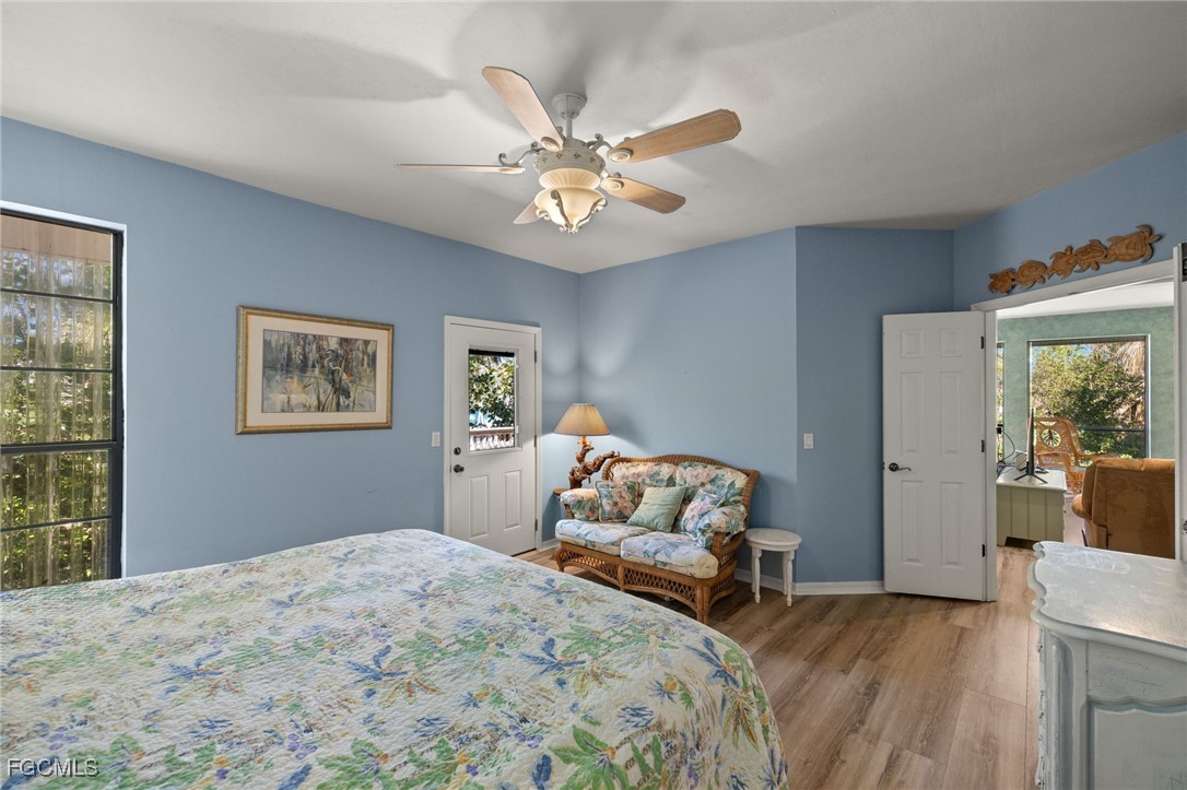 4631 Bowen Bayou Road Sanibel, FL 33957 - Photo 16 of 39 a bedroom with a bed and a chandelier