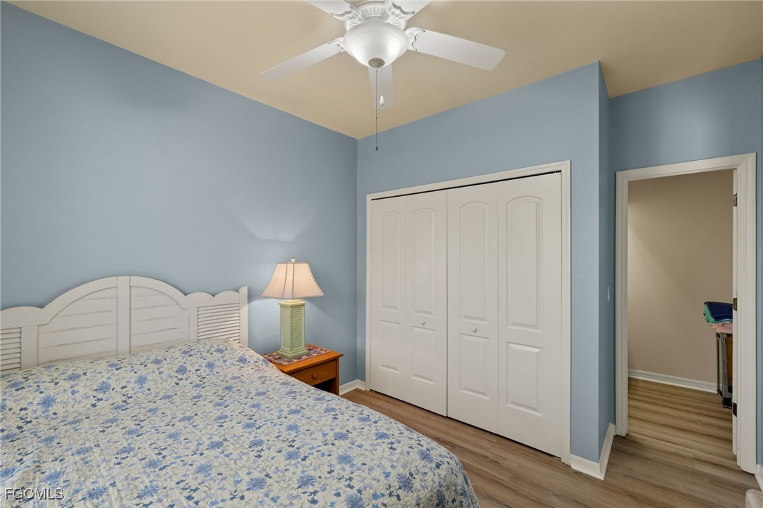 4631 Bowen Bayou Road Sanibel, FL 33957 - Photo 21 of 39 a bedroom with a bed and a chandelier
