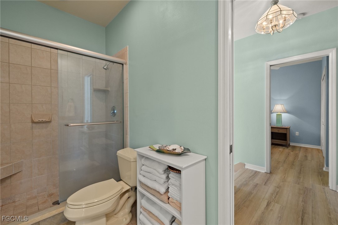 4631 Bowen Bayou Road Sanibel, FL 33957 - Photo 22 of 39 a bathroom with a granite countertop sink a toilet a mirror and shower