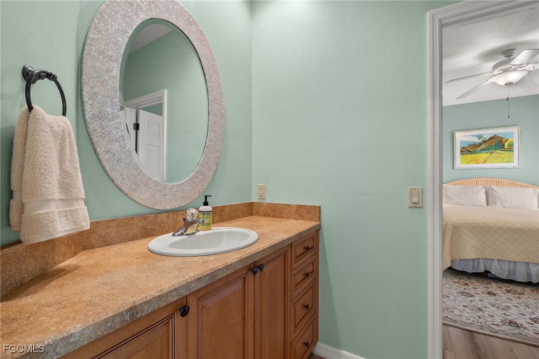 4631 Bowen Bayou Road Sanibel, FL 33957 - Photo 23 of 39 a bathroom with a granite countertop sink and a mirror