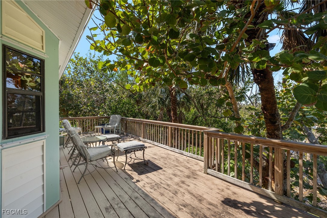 4631 Bowen Bayou Road Sanibel, FL 33957 - Photo 27 of 39 a view of balcony with wooden floor and seating space