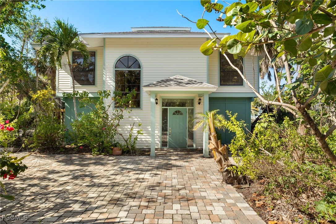 4631 Bowen Bayou Road Sanibel, FL 33957 - Photo 3 of 39 a front view of a house with garden