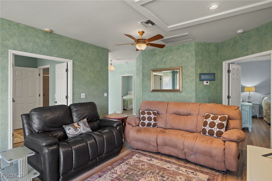 4631 Bowen Bayou Road Sanibel, FL 33957 - Photo 7 of 39 a living room with furniture and a ceiling fan