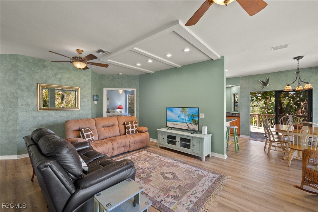 4631 Bowen Bayou Road Sanibel, FL 33957 - Photo 8 of 39 a living room with furniture and wooden floor
