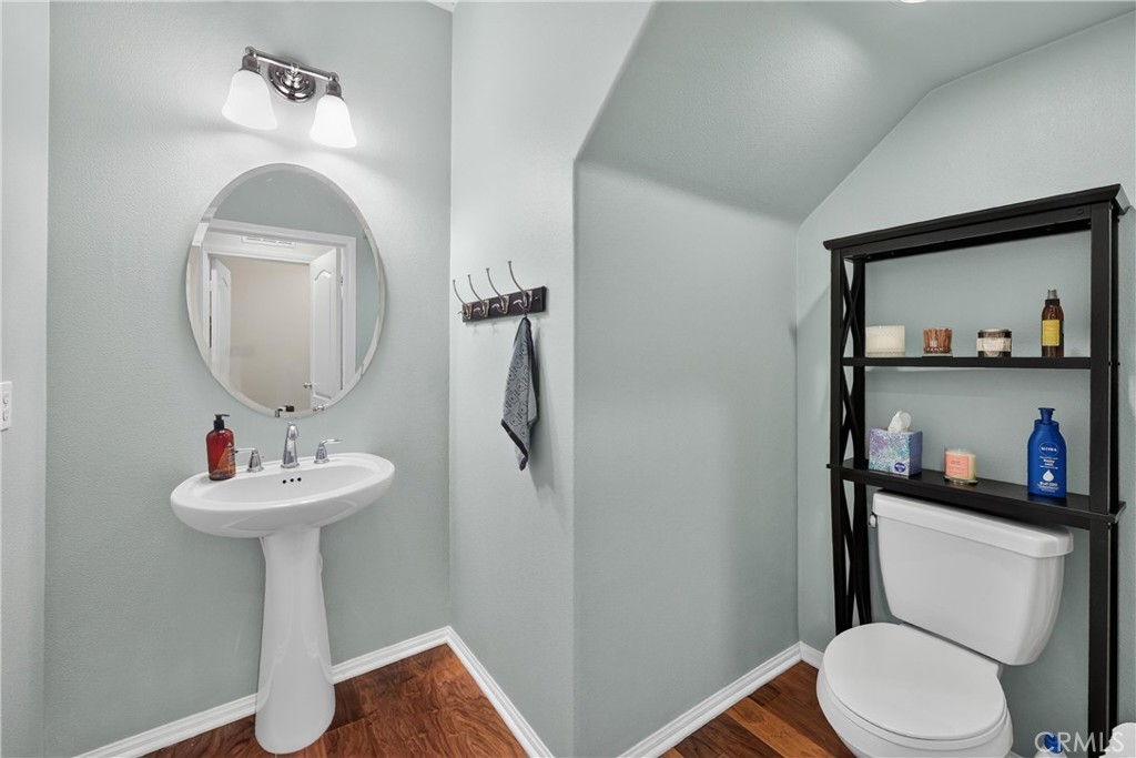 849 The Promenade, Unit D Azusa, CA 91702 - Photo 18 of 37 a bathroom with a toilet sink and mirror
