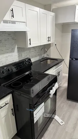 a stove top oven sitting inside of a kitchen