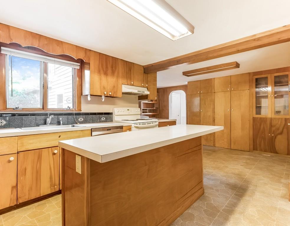 17 Nashoba Road Acton, MA 01720 - Photo 11 of 26 a kitchen with stainless steel appliances granite countertop a sink a stove and a refrigerator