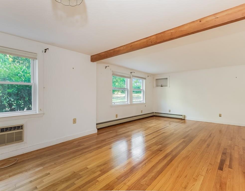 17 Nashoba Road Acton, MA 01720 - Photo 13 of 26 a view of an empty room with wooden floor and a window