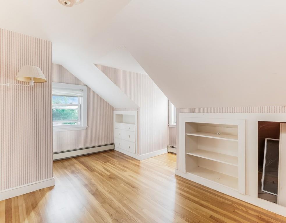 17 Nashoba Road Acton, MA 01720 - Photo 18 of 26 an empty room with wooden floor cabinet and windows