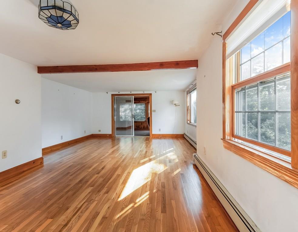 17 Nashoba Road Acton, MA 01720 - Photo 5 of 26 a view of empty room with wooden floor and fan