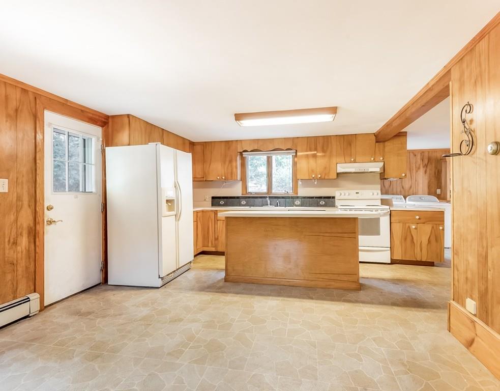 17 Nashoba Road Acton, MA 01720 - Photo 6 of 26 a large kitchen with stainless steel appliances granite countertop a stove a sink and a refrigerator