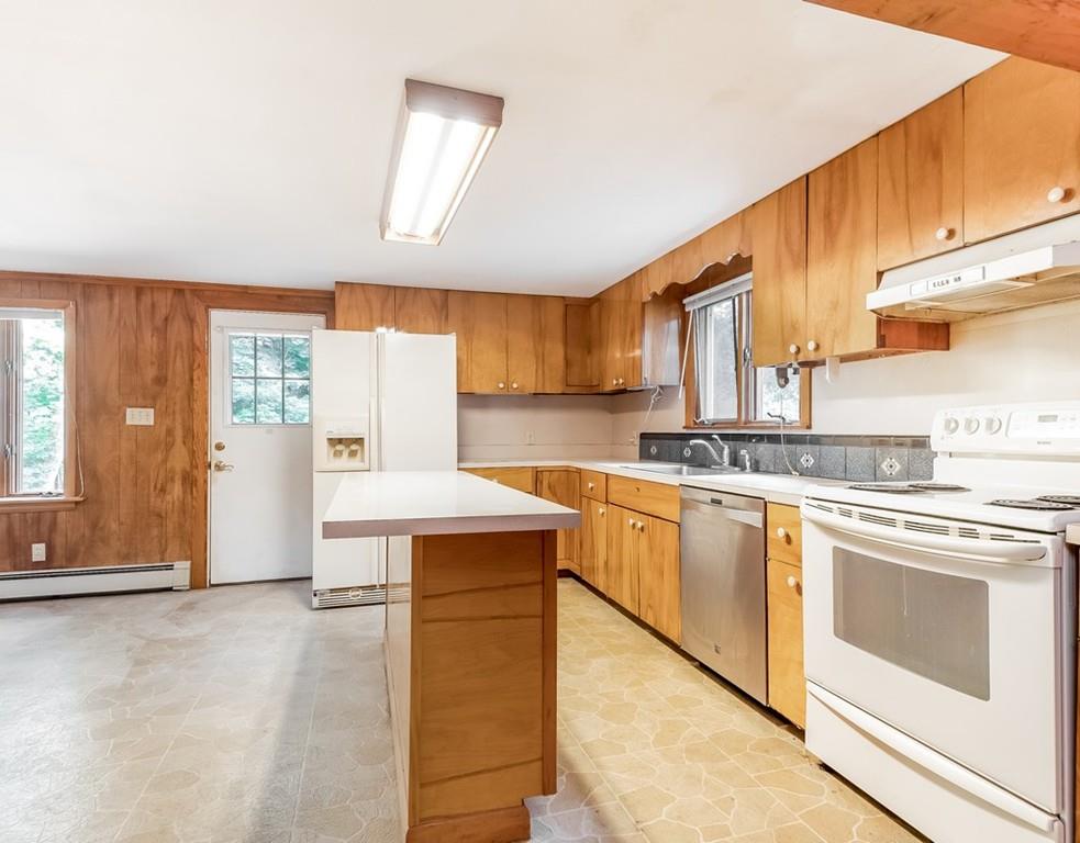 17 Nashoba Road Acton, MA 01720 - Photo 9 of 26 a kitchen with stainless steel appliances granite countertop a stove a sink and a refrigerator