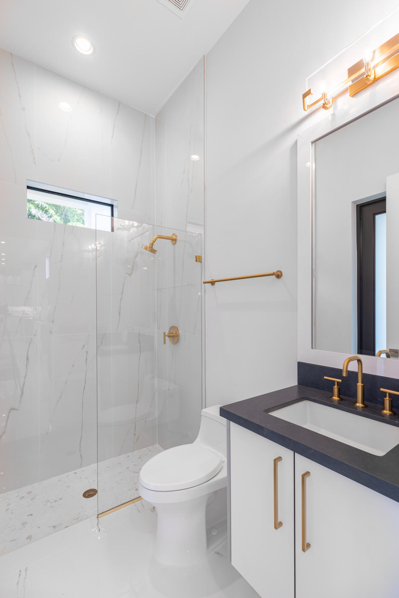 2740 Northwest 69th Street Boca Raton, FL 33496 - Photo 54 of 79 a bathroom with a sink a toilet and shower