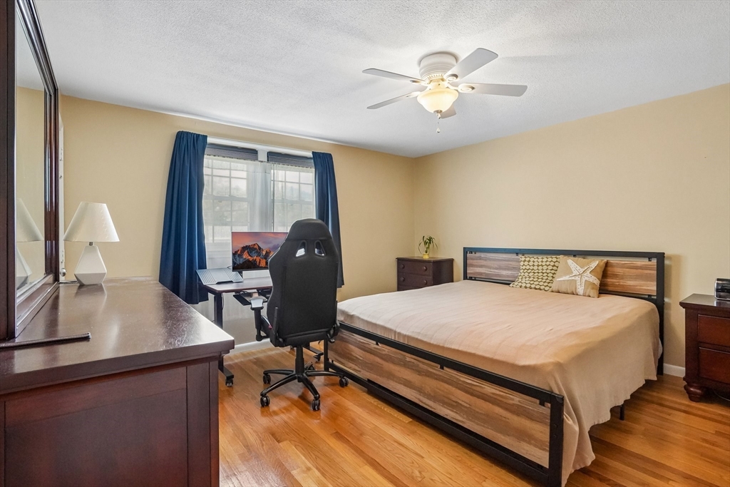 35 Westgate Road Framingham, MA 01701 - Photo 23 of 37 a bedroom with a bed and a chandelier