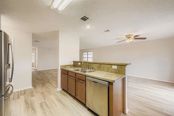 a kitchen with a stove and a refrigerator