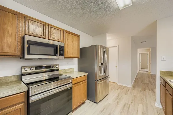 a kitchen with stainless steel appliances a stove a microwave and cabinets
