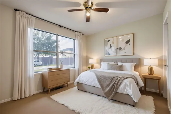 a bedroom with a large bed and a large window