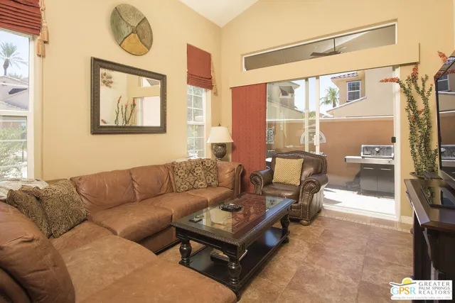a living room with furniture and a floor to ceiling window