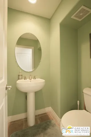 a bathroom with a sink toilet and mirror