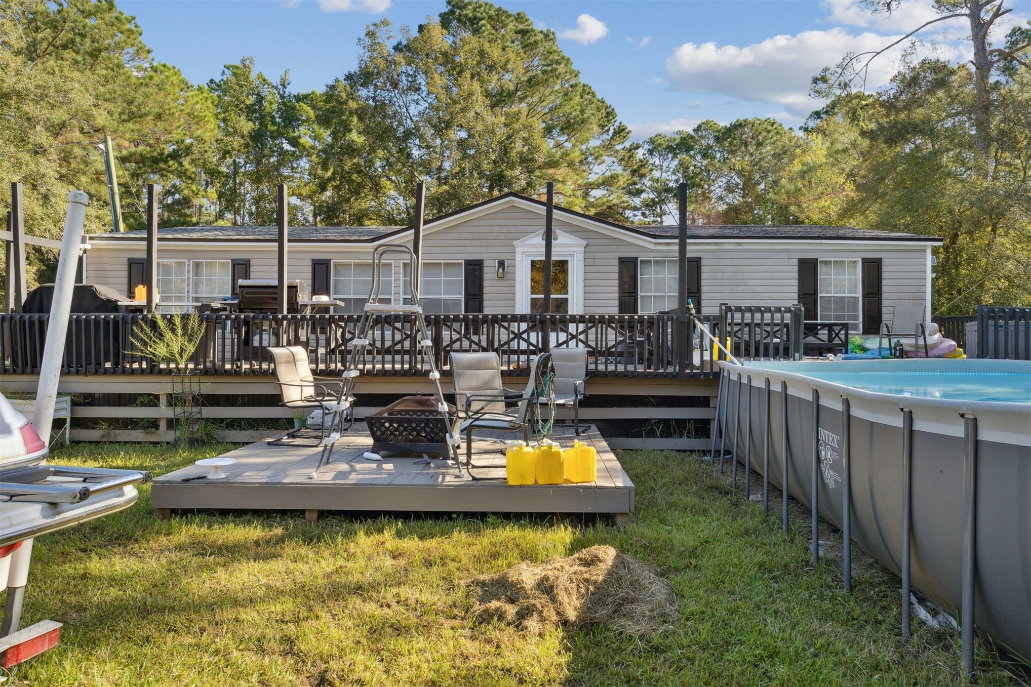 a view of a backyard with swimming pool