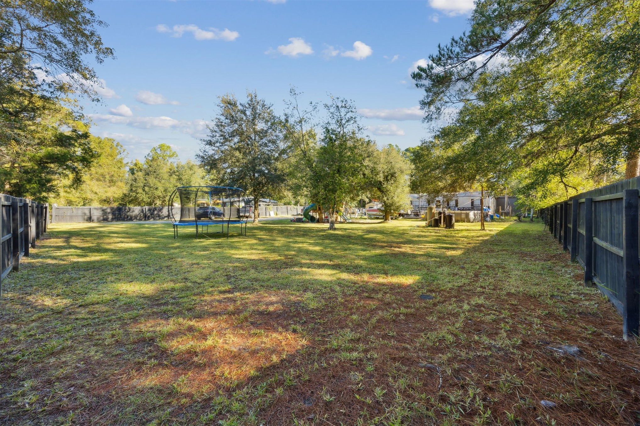 15461 Dewanna Road Jacksonville, FL 32218 - Photo 20 of 27 a view of a grassy field with trees