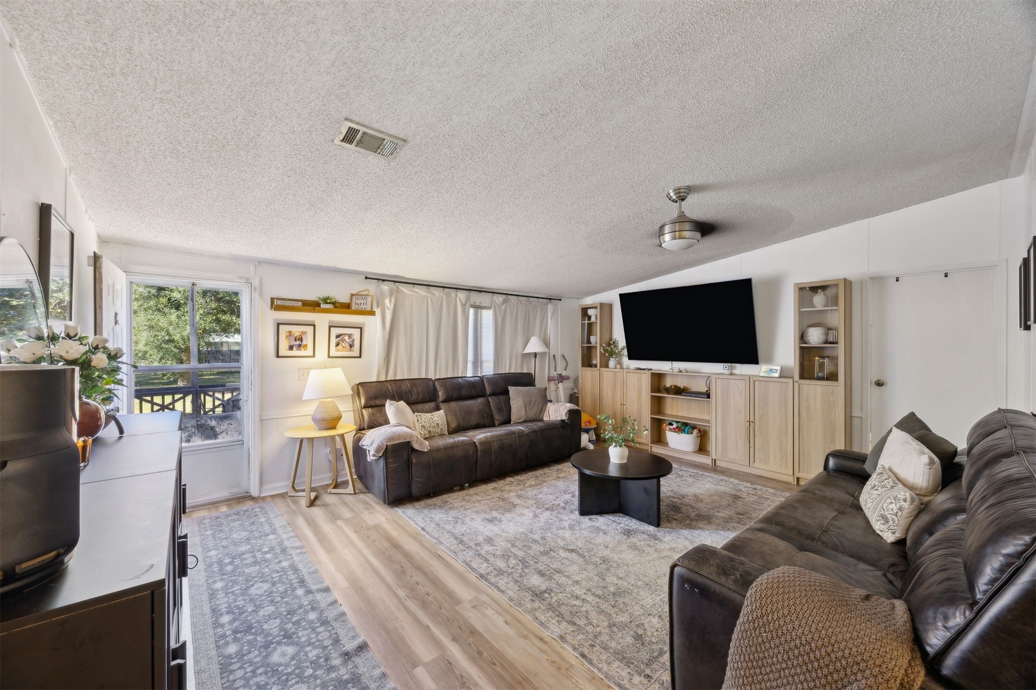 15461 Dewanna Road Jacksonville, FL 32218 - Photo 8 of 27 a living room with furniture and a flat screen tv