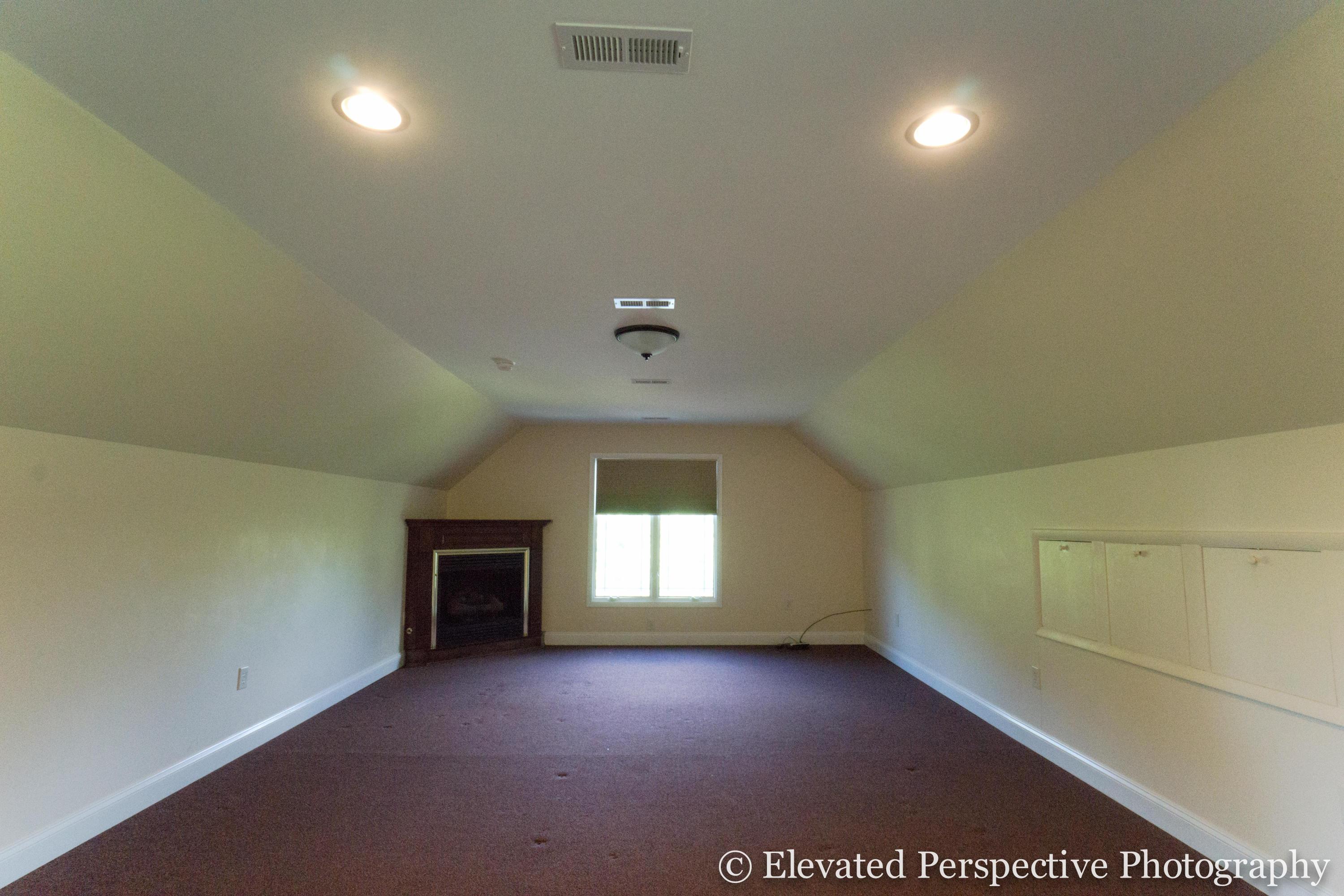 930 Northridge Road Hardy, VA 24101 - Photo 22 of 36 an empty room with a fireplace and wooden floor