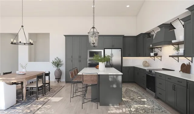 a dining hall with stainless steel appliances kitchen island granite countertop a sink a counter top space and dining table